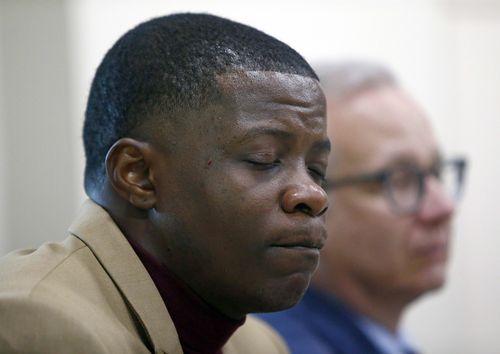 Shaw holds back tears during a press conference on the shooting. (AP)