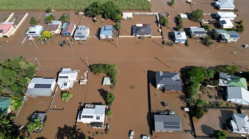 An aerial drone view shows houses inundated by floodwater in Woodburn in northern NSW.  