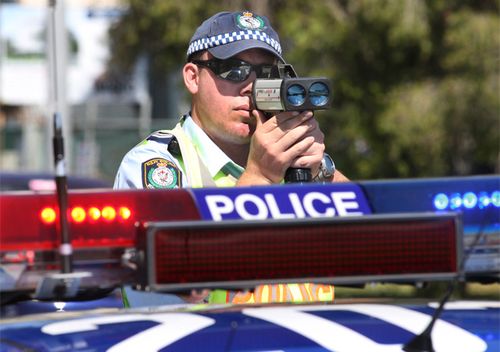 A NSW police officer zeroes his speed camera on cars