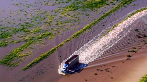 Mr Shepherd lost all his crops in the deluge, and launched a fundraising calendar with his aerial shots, including an image of a farm truck battling through floodwater.