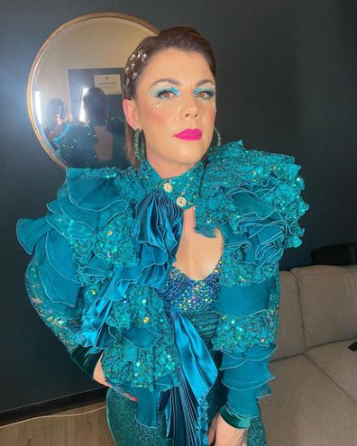 Em Rusciano poses in a blue ensemble.