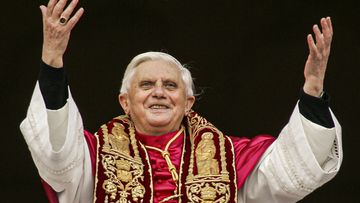 Pope Benedict XVI greets the crowd from the central balcony of St. Peter&#x27;s Basilica at the Vatican on April 19, 2005, soon after his election. 