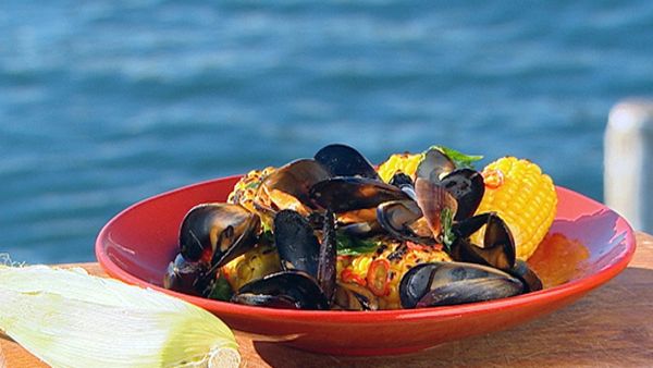Platter of barbecue mussels and corn with roasted garlic butter