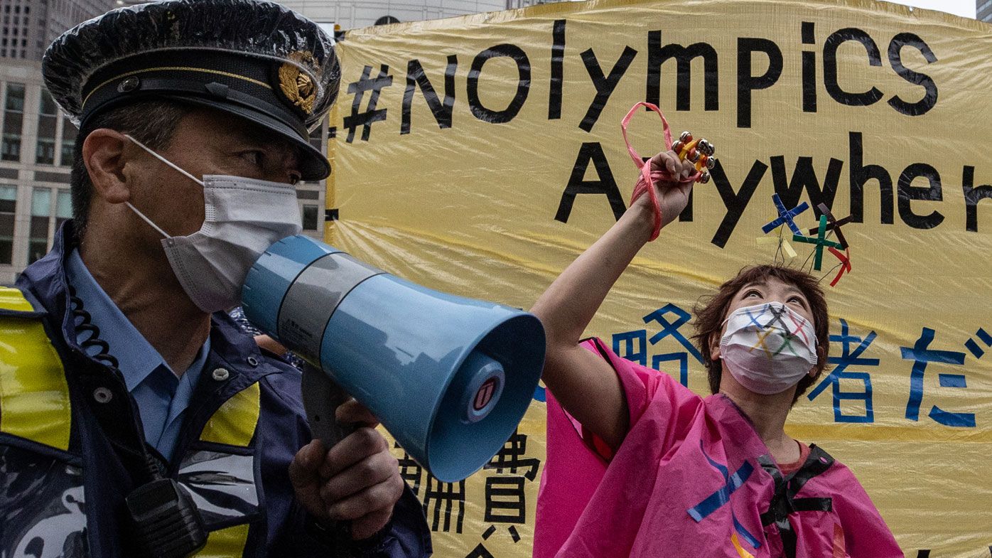 Protesters chant slogans outside the metropolitan government building during a protest against the Tokyo 2020 Olympic Games. 