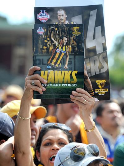 Hawks fans holds up one placard of one of her poster boys.