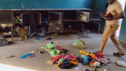 A man walk past belongings at the St. Mary's Catholic Primary and Secondary School after gunmen abducted children and staff in Papiri community, Nigeria, Friday, Nov. 21, 2025. (Christian Association of Nigeria via AP)