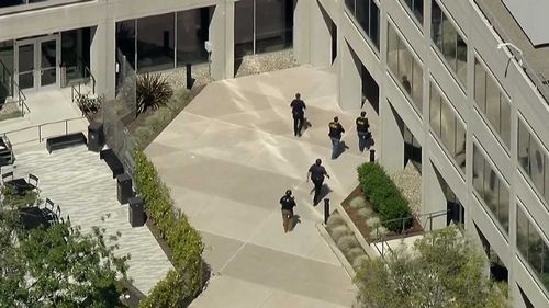 Police walk into the YouTube headquarters in San Bruno, California. (ABC America)