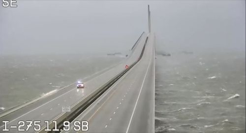 This image provided by FLDOT shows an emergency vehicle traveling on the Sunshine Skyway over Tampa Bay, Florida, on Wednesday, Sept. 28, 2022.  