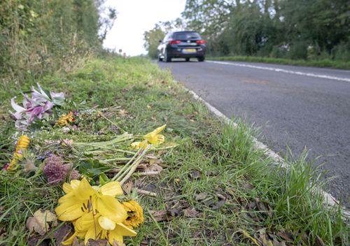 Floral tributes on the B4031 outside RAF Croughton, in Northamptonshire, where Harry Dunn, 19, died when his motorbike was involved in a head-on collision in August.