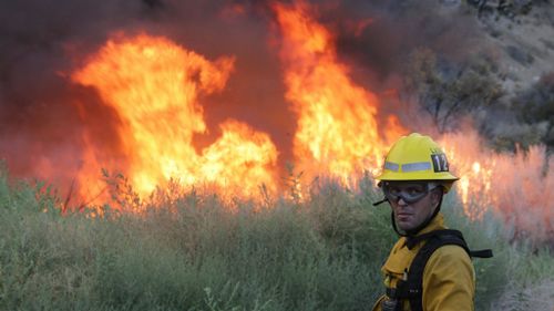 An estimated 2,000 personnel have been battling the blaze. (AAP)