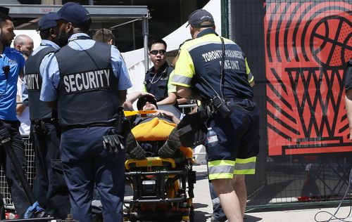 Paramedics attend to a fainted Toronto Raptors fan at Nathan Phillips Square. Mandatory Credit: John E. Sokolowski-USA TODAY Sports.