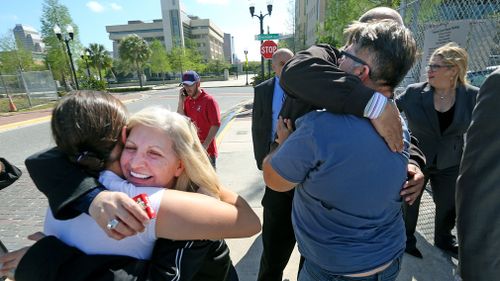 Family members of Noor Salman receive hugs from friends after a jury found Salman not guilty on all charges. (AP)