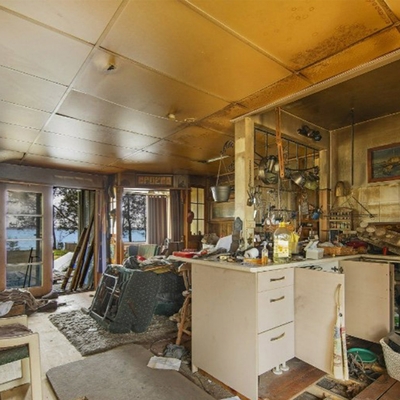 Fire-damaged home with soot, sagging ceilings and floors coming undone is heading to auction