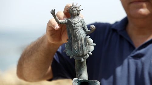 Jacob Sharvit, director of the Marine Archaeology Unit of the Israel Antiquities Authority displays one of the archeological finds. (AAP)