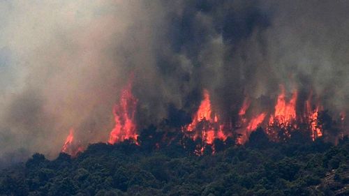 Flames are burning land in a forest fire declared in Almorox, Toledo, Spain, 29 June 2019. Firefighters continue working to extinguish the fire as it has already reached Cadalso de los Vidrios in Madrid's region.  