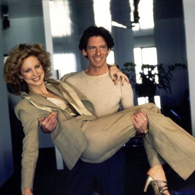 Designer Calvin Klein carrying model Rosie Vela through his New York apartment.