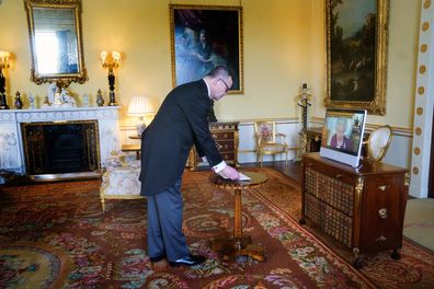 Queen Elizabeth II, in residence at Windsor Castle, appears on a screen via videolink, during a virtual audience to receive Professor Piotr Wilczek, Ambassador of Poland, at Buckingham Palace, London Tuesday March 22, 2022.   