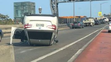 A car has rolled onto its roof on the Sydney Harbour Bridge after reportedly hitting the side of a tollgate. 
