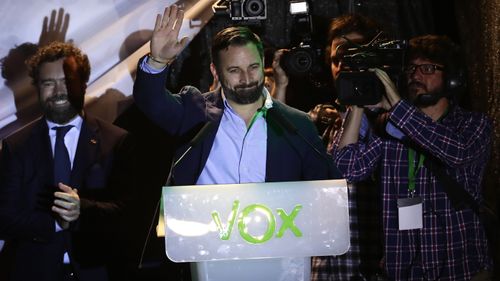 Santiago Abascal, leader of far right party Vox, waves to supporters gathered outside the party headquarters in Madrid.