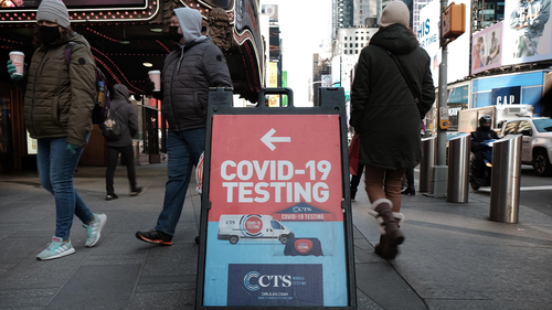 People pass COVID-19 testing site along a Manhattan street on January 21 in New York City. 
