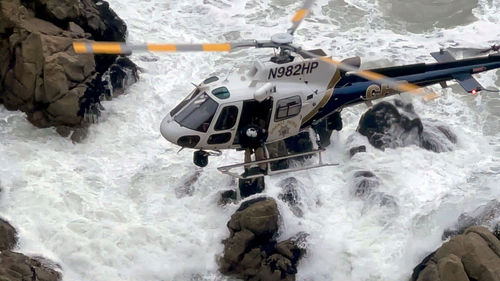 A California Highway Patrol helicopter navigated the rugged coastline to rescue two occupants of the car.