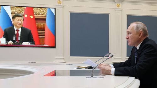 Russian President Vladimir Putin speaks during a meeting with Chinese President Xi Jinping, seen onscreen,  via  a video conference at the Kremlin in Moscow, Russia, Friday, Dec. 30, 2022 