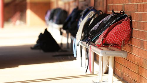 School bags lined up outside classroom.