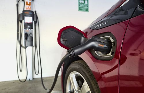 FILE - A Chevrolet Volt hybrid car is seen charging at a ChargePoint charging station at a parking garage in Los Angeles, Oct. 17, 2018. New vehicles sold in the U.S. will have to average about 38 miles per gallon of gasoline in 2031 in real world driving, up from about 29 mpg this year, under new federal rules unveiled Friday, June 7, 2024, by the Biden administration. President Joe Biden has set a goal that half all of new vehicles sold in the U.S. in 2030 are electric. (AP Photo/Richard Vogel