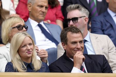 Peter Phillips, the son of Britain's Princess Anne sits in the Royal Box with girlfriend Lindsay Wallace before a men's singles quarterfinal match on day ten of the Wimbledon tennis championships in London, Wednesday, July 6, 2022