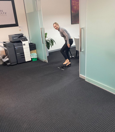 female ceo vacuuming legal firm office