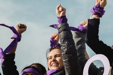 Feminist protest with women expressing empowerment and leadership to achieve woman's rights International Women's Day