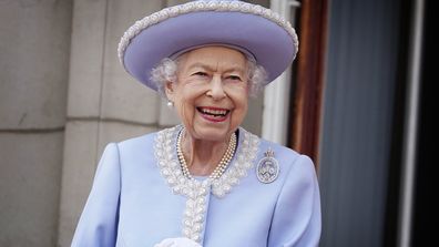 Queen Elizabeth II watches with a smile from the balcony of Buckingham Palace after the Trooping the Color ceremony in London, Thursday, June 2, 2022, on the first of four days of celebrations to mark the Platinum Jubilee. The events over a long holiday weekend in the U.K. are meant to celebrate the monarch's 70 years of service. (Jonathan Brady/Pool Photo via AP)