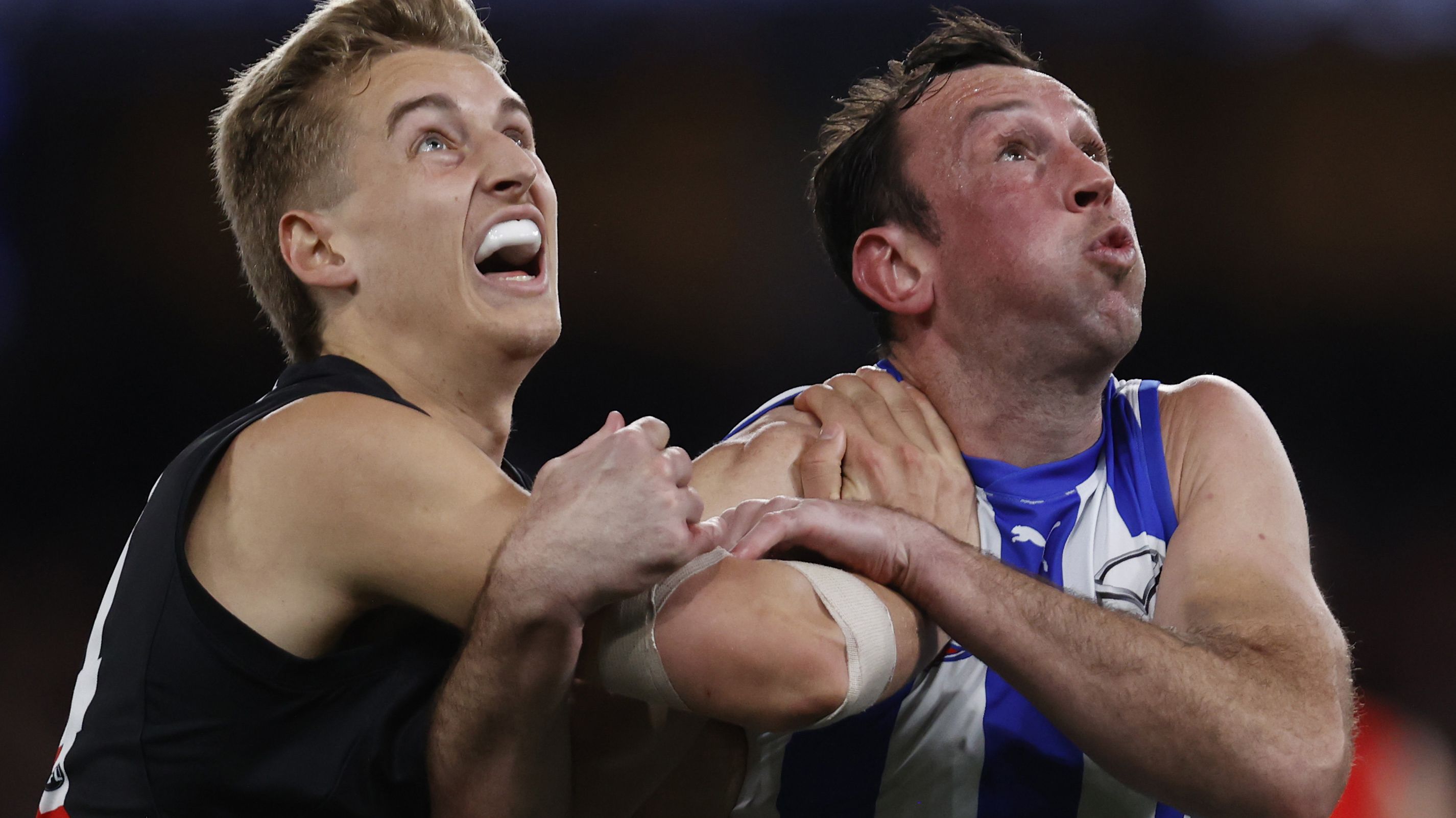 MELBOURNE, AUSTRALIA - AUGUST 12: Nick Bryan of the Bombers  competes with Todd Goldstein of the Kangaroos during the round 22 AFL match between North Melbourne Kangaroos and Essendon Bombers at Marvel Stadium, on August 12, 2023, in Melbourne, Australia. (Photo by Darrian Traynor/Getty Images)