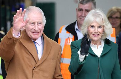 King Charles III and Queen Camilla smile and wave during the launch of the Coronation Food Project and the visit to the South Oxfordshire Food and Education Alliance, a surplus food distribution centre, on November 14, 2023 in Didcot, England.  