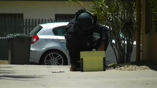 Specialist police in bomb suits attended the scene. (9NEWS)