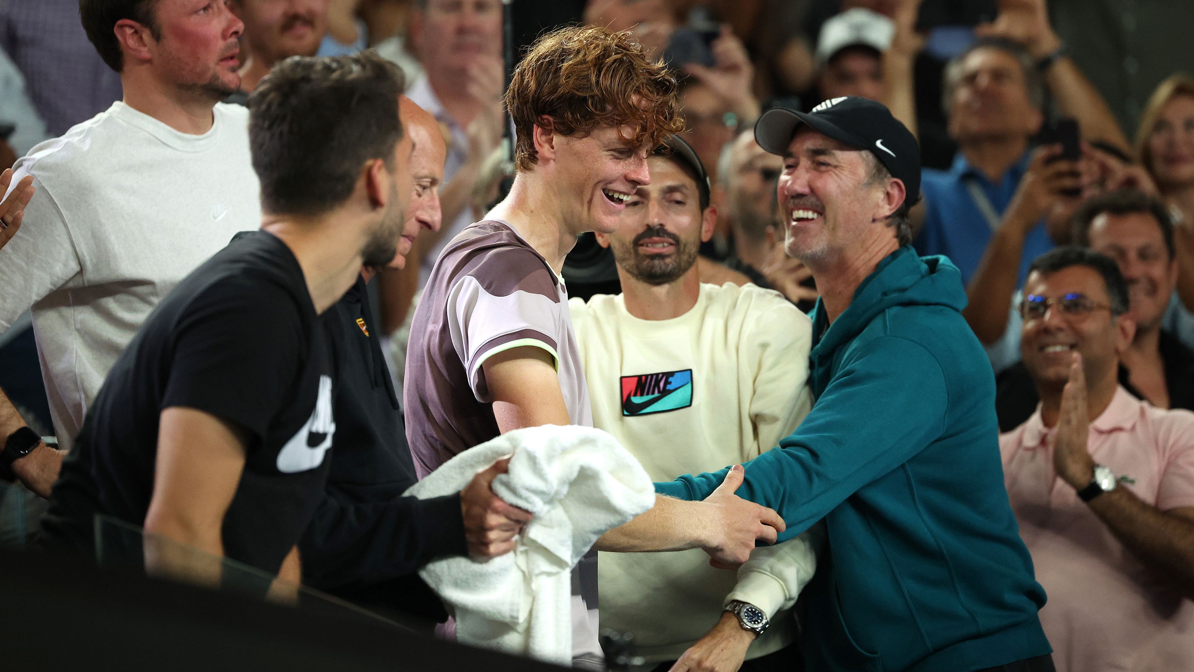 Jannik Sinner of Italy celebrates winning with coach Darren Cahill and his team.