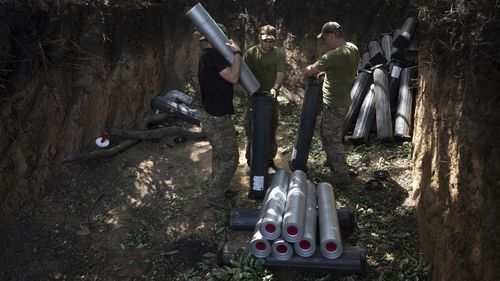 Ukrainian servicemen prepare ammunition for self-propelled howitzer "Bohdana" before firing towards Russian positions near Bakhmut, Ukraine, Friday, July 7, 2023.