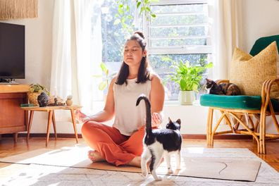 A woman doing yoga at home