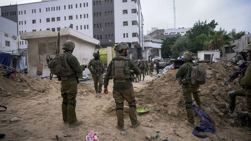 Israeli soldiers stand outside Shifa Hospital 