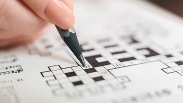 woman completing crossword