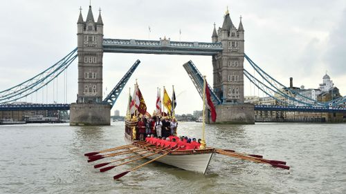 A Royal River Salute sails under Tower Bridge in London.