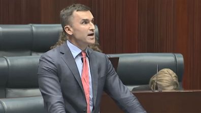 John Carey rocks a mullet in Parliament thanks to Jessica Shaw.