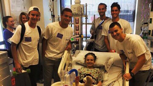 The fraternity brothers have become friends with Lexi Brown who has stayed in the hospital across the road from their house. (Facebook)
