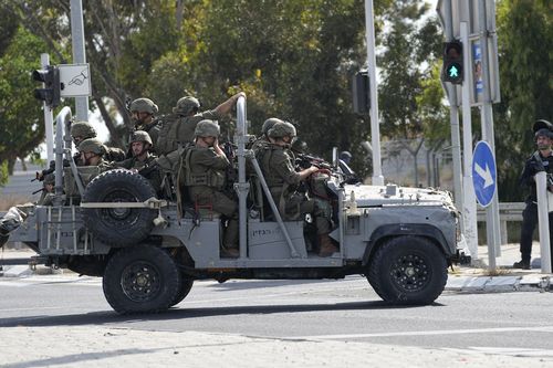 Israeli soldiers head south near Ashkelon, Israel, Israel, on Saturday, Oct. 7, 2023. 