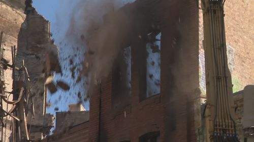 The demolition of an inner-Sydney building that was gutted by fire last week has begun after authorities searched the rubble.