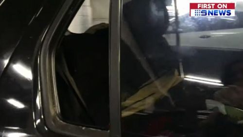 Firefighters removed one of the car's windows. (9NEWS)