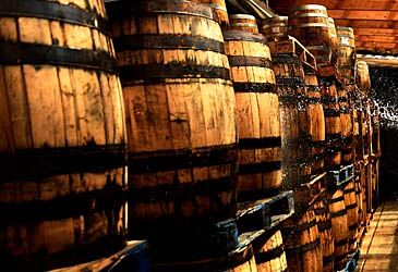 US laws require American whiskies to be aged in what type of barrels?