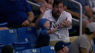 Adorable moment young boy throws baseball to field after lucky 'catch'