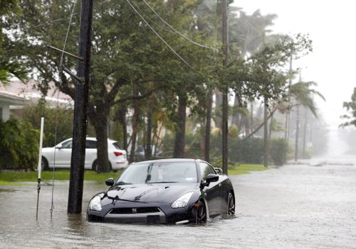 A car is parked on a flooded road as Hurricane Irma passes through Surfside. (AP)