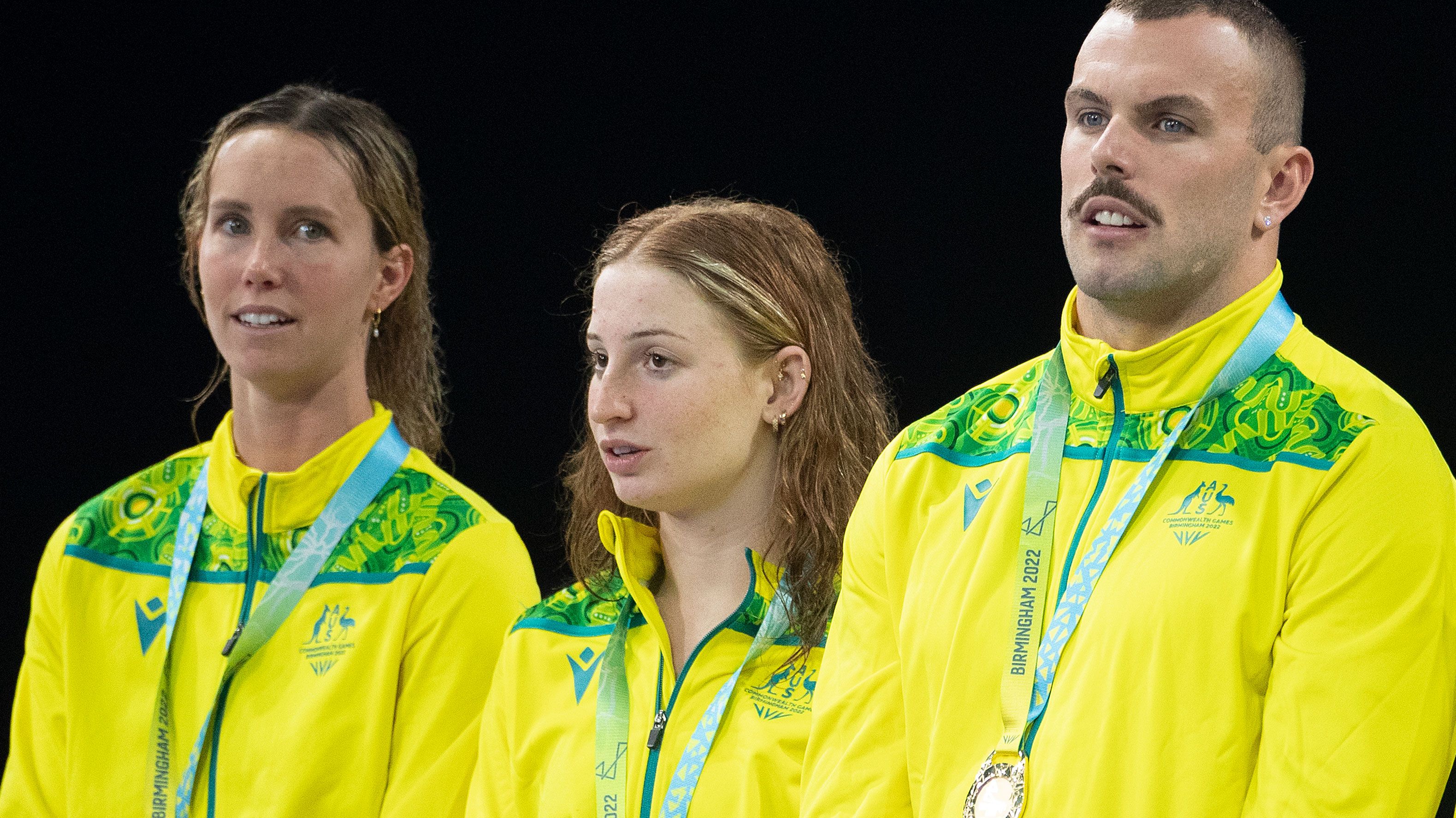 Emma McKeon (left) and Kyle Chalmers (right), are separated on the podium by Mollie O&#x27;Callaghan after winning the mixed 4x100m freestyle relay.